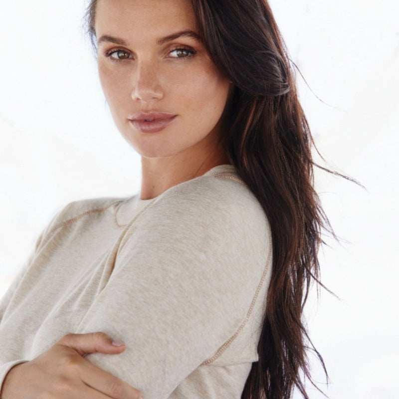 Image of woman wearing lynx light beige organic cotton crewneck with tonal rib stitching.