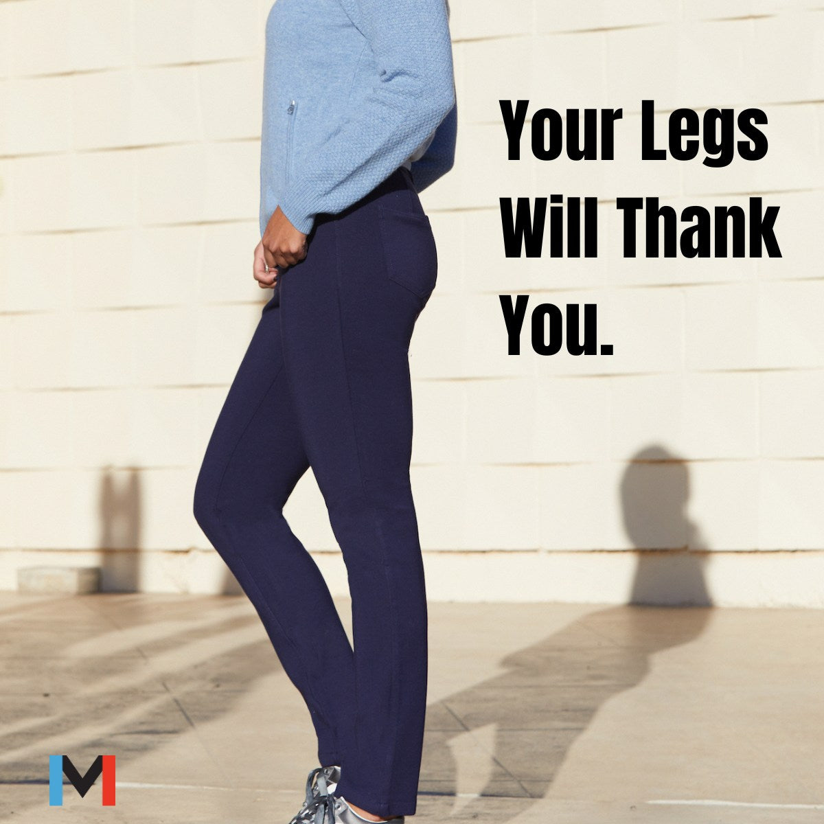 Sustainable and Sportily Dressed in Movetes. Side profile showing Mina Tobias wearing the Navy Eliza Stretch Jersey Pant. This tailored jersey stretch 5-Pocket pant has a classic jeans look and a smooth fit through the leg.