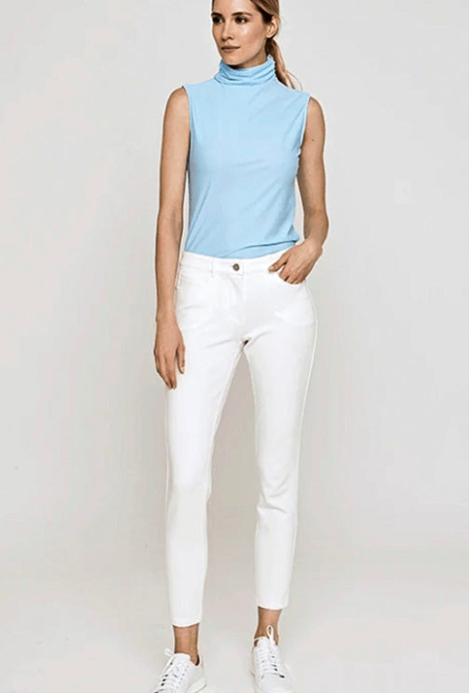 Photo of model wearing the Ivory Eliza 5-Pocket Jersey Stretch Pant.  This iconic Movetes sportswear style embraces functionality, movement and Effortless dressing up or down. A Versatile style you'll wear for years.  Machine Washable.